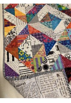 a close up of a colorful quilt on a table