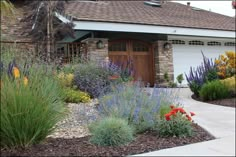 a house with lots of flowers in front of it