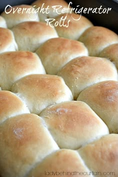 a close up of bread in a pan with the words overnight refrigerator rolls