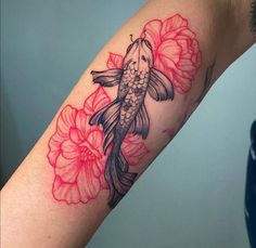 a tattoo with a fish and flowers on it's arm that is black and red