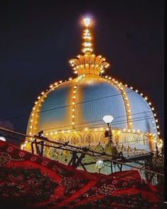 an ornate building with lights on it's roof