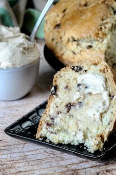 a piece of cake on a plate with ice cream next to it and a spoon