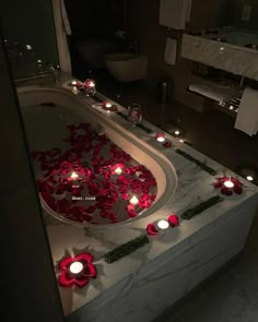 a bath tub with candles and flowers on it