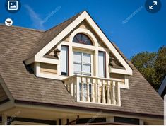 a white house with a brown roof and windows