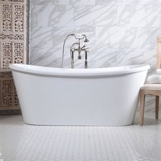 a white bath tub sitting next to a wooden chair