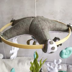 a stuffed animal hanging from a wooden hoop