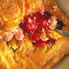 a close up of food in a pan with a spoon and fork next to it