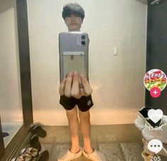 a person taking a selfie in front of a mirror with their feet on the ground