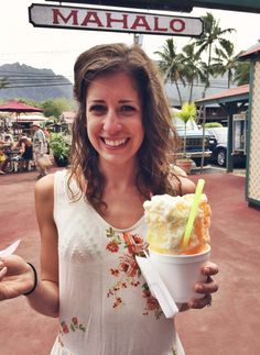 a woman holding up an ice cream sundae