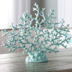 a blue coral sculpture sitting on top of a wooden table