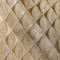 a close up view of a metallic wallpaper with wavy lines and diamond shapes on it