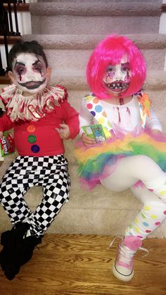 two clowns are sitting on the stairs together