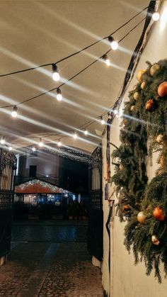 an indoor area with lights and garlands on the wall, along with a clock