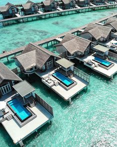 an aerial view of some water villa's in the middle of the ocean,