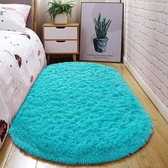 a bedroom with a bed and a blue rug on the floor