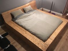 a bed that is made up and has pillows on it