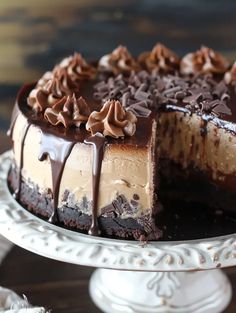 a chocolate cheesecake with one slice cut out on a cake platter, and the rest half eaten