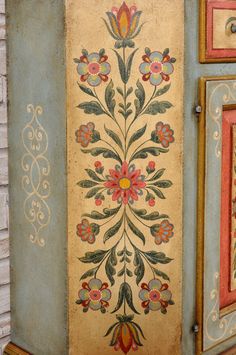 an old painted cabinet with flowers on it