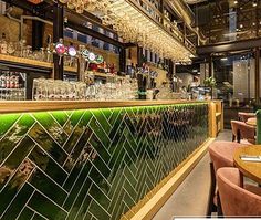 the interior of a restaurant with many tables and chairs