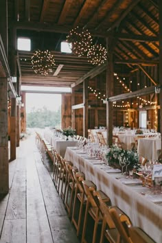 the tables are set with white linens and place settings for guests to sit at