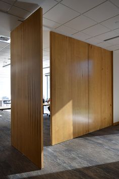 an empty room with wooden partitions in the middle