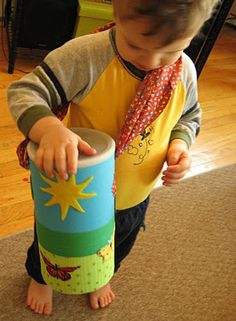 a little boy playing with a toy on the floor