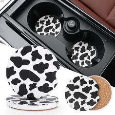 two black and white cow print coasters next to a toaster