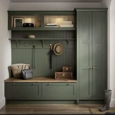 a room with green cupboards and some items on the shelf in front of it