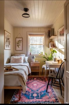 a bedroom with a bed, desk and chair in it next to a doorway leading to another room