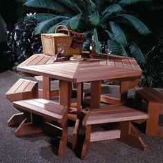 a wooden picnic table with benches and a basket on the back ground next to it