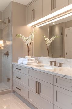 a bathroom with two sinks and a large mirror over it's shower stall area