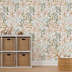 the wallpaper in this room is very pretty and has flowers on it, as well as wicker baskets