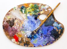 a paint palette with a brush sitting on top of it