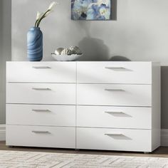 a white dresser with several drawers in a room