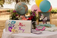 a table topped with balloons and pictures