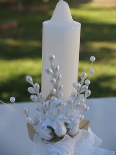 a white candle is sitting on a table