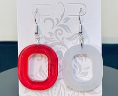 Detroit Red Wings Earrings, almost time for our Detroit Team to play in Hockey Town. Made with Red & White resin in round mold, I wanted to represent our Detroit Red Wings. Maybe this year we can bring home the Stanley Cup! No one will have these pair of earrings but you. One of a Kind and unique pair you will stand out anywhere or anytime you wear them. Custom made to order makes a perfect gift for you or your friends and family. Can be made within an hour. Trendy Red Resin Earrings, Nickel-free Red Resin Jewelry, Handmade Red Resin Jewelry, Wings Earrings, Round Moulding, Resin Pour, Wing Earrings, Detroit Red Wings, Wedding Jewelry Earrings