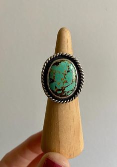 This handmade statement ring features a beautiful, think oval cut of natural Royston turquoise. The stone is set in fine and sterling silver and is surrounded by a rope shadow box. The whole thing is darkened with patina to bring out the detail and polished to a shiny finish. The double ring band is a US size 6.5. Can be sized up slightly, if you don't mind a hammered texture on the band. Cannot be sized down. Makes a great gift! Ready to ship Rope Border, Silver Turquoise Ring, Royston Turquoise, Double Ring, Ring Band, Silver Turquoise, Turquoise Sterling Silver, Statement Ring, Rings Statement