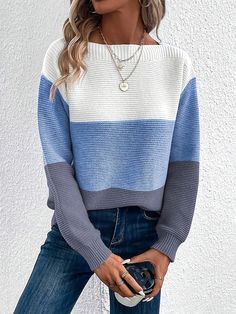 a woman wearing a blue, white and grey striped sweater with jeans on the side