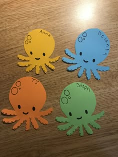 three octopus cut outs sitting on top of a wooden table