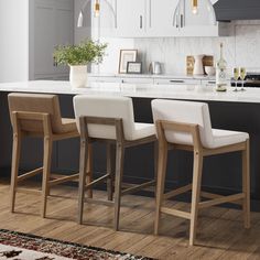 three stools in front of a kitchen island