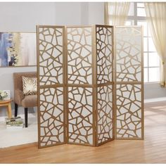 the room divider is made out of wood and has an intricate design on it