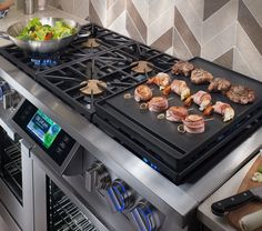 a stainless steel stove top with food cooking on it