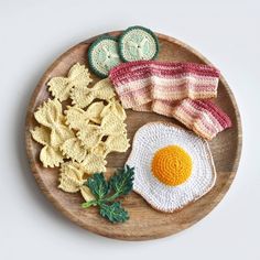 a wooden plate topped with chips and an egg