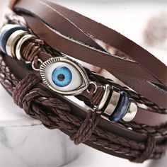 Infuse your day-to-day ensembles with bohemian-inspired flair when you wear this faux leather bracelet adorned with an evil eye pendant. 12.05'' L 13.46'' L 12.76'' L Sliding bead closure Silvertone copper / polyurethane / enamel Brown Evil Eye, Braided Rope Bracelet, Rope Bracelets, Basket Woven, Punk Jewelry, Simple Bracelets, Braided Rope, Eye Pendant, Woven Bracelets