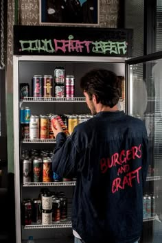 a man standing in front of a refrigerator filled with food