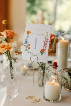 a table with flowers and candles on it