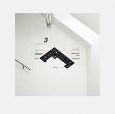 a clock that is on the side of a wall with numbers and arrows around it