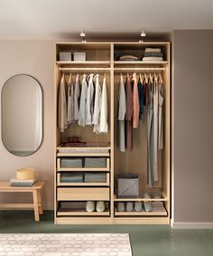 an open closet with clothes hanging on hangers and a bench in front of it