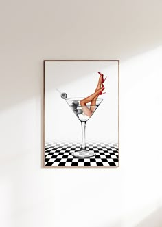 a woman's legs in a martini glass on a checkered floor